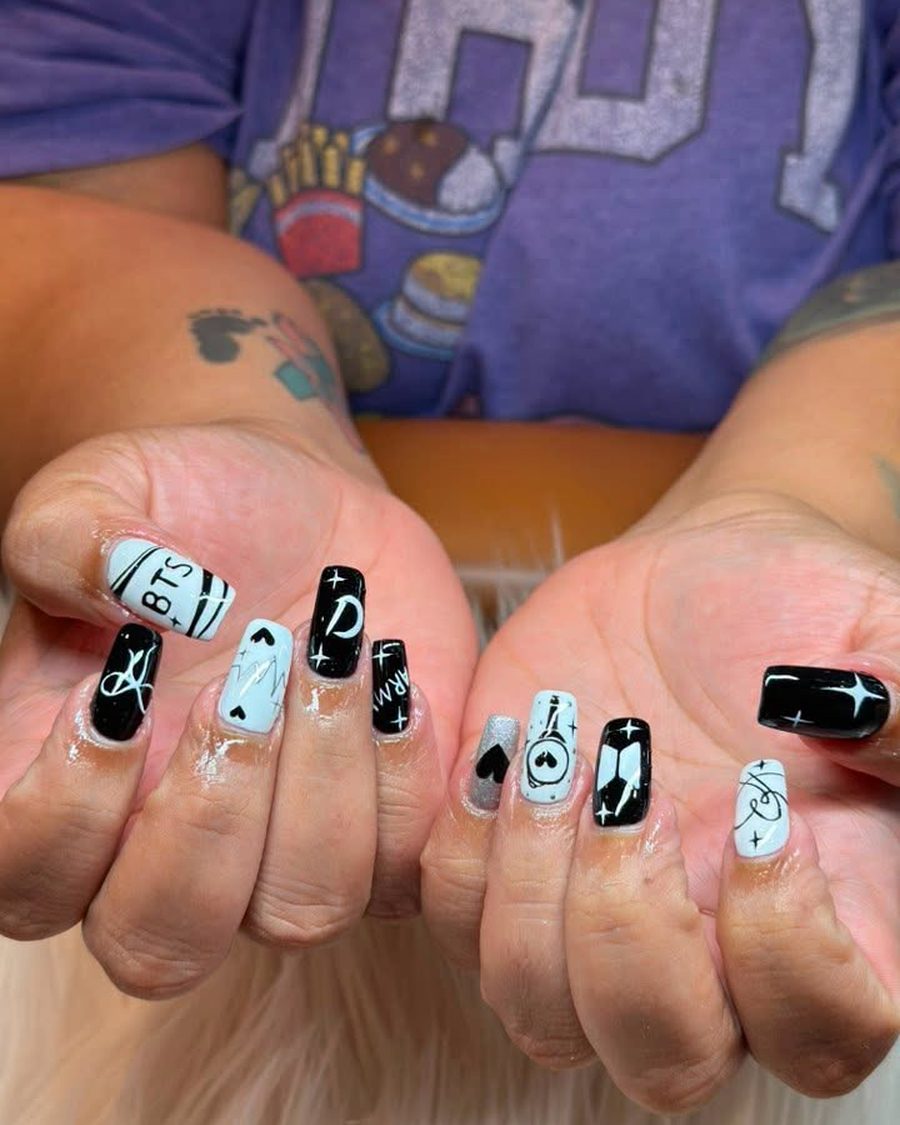 Black and white hand-painted nail art on short square nails
