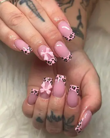 Pink cow-print French coffin nails with 3D bow accents