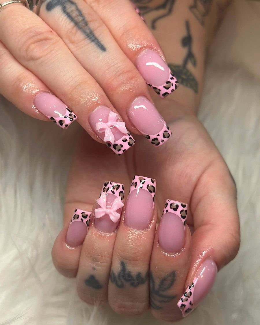Pink cow-print French coffin nails with 3D bow accents