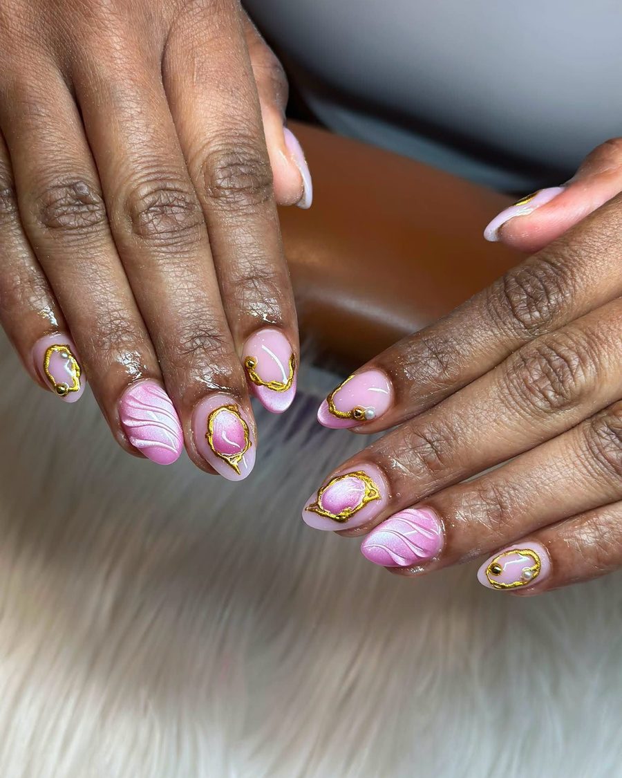 Pink swirl and gold line art on almond acrylic nails