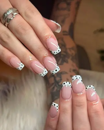 Nude almond French with black polka-dot tips