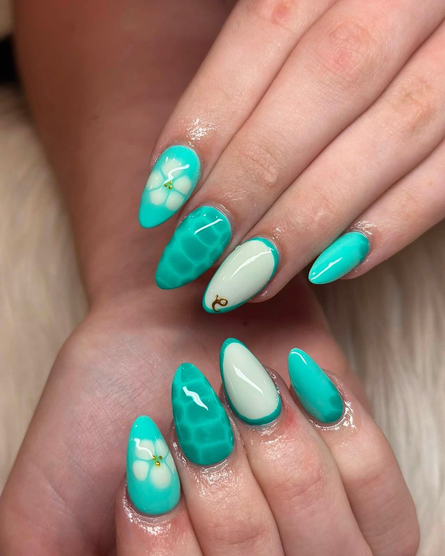 Teal green almond nails with white floral accents