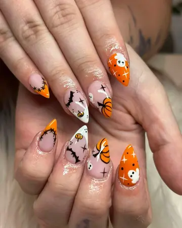 Halloween nail art with pumpkins, bats and ghosts on almond nails