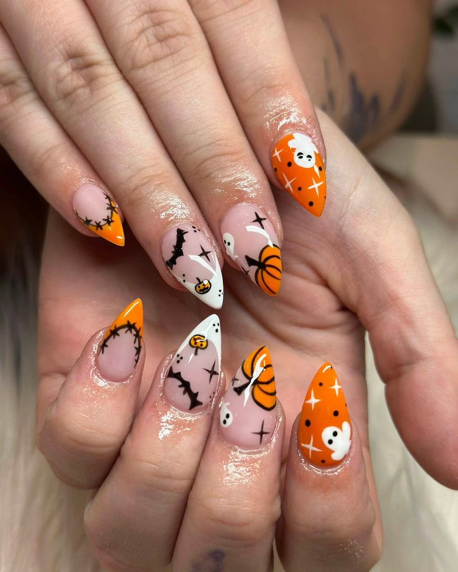 Halloween nail art with pumpkins, bats and ghosts on almond nails