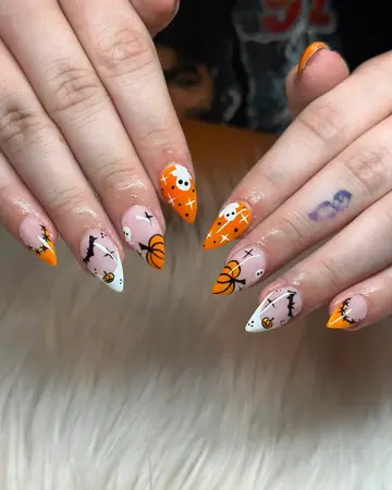 Orange and black Halloween French tips on almond nails