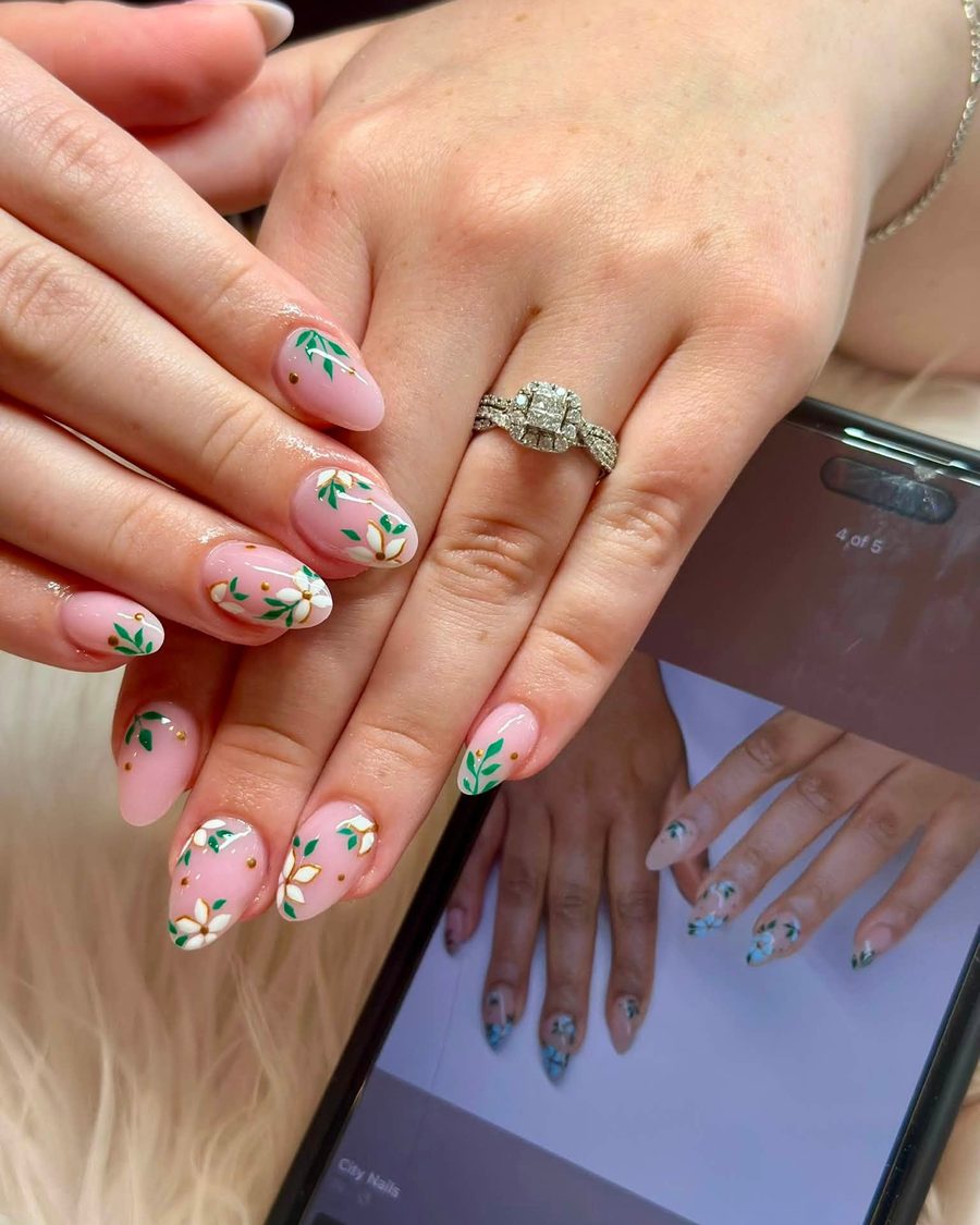 Short nude almond nails with green leaf and floral art