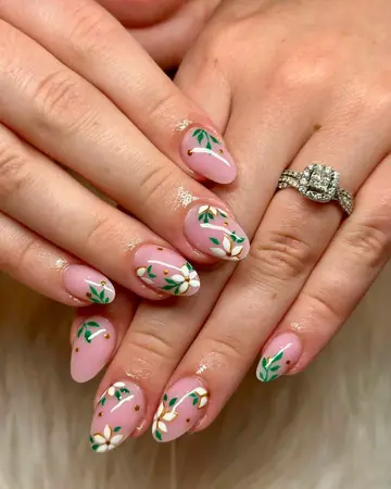 Nude almond nails with olive branch leaf art and glitter