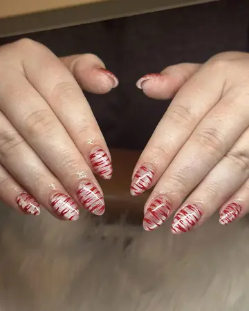Nude nails with red candy stripe art