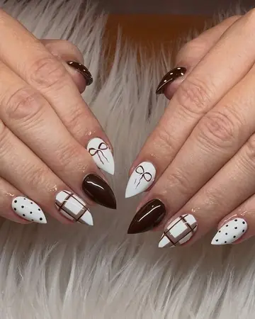 Brown and white stiletto nails with hand-painted bows, plaid and polka dots