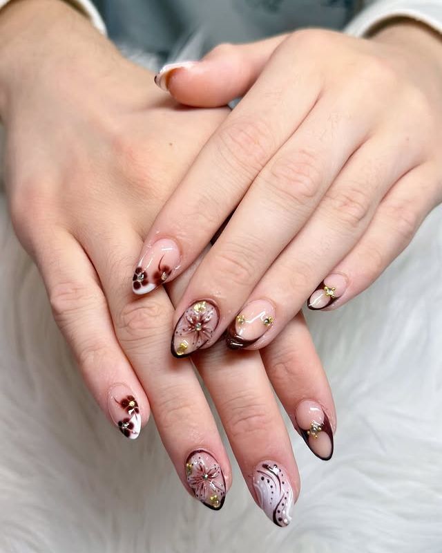 Nude almond nails with brown French tips and fall flowers