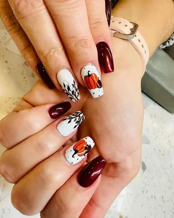 Burgundy shimmer coffin nails with hand-painted pumpkins and fall branches