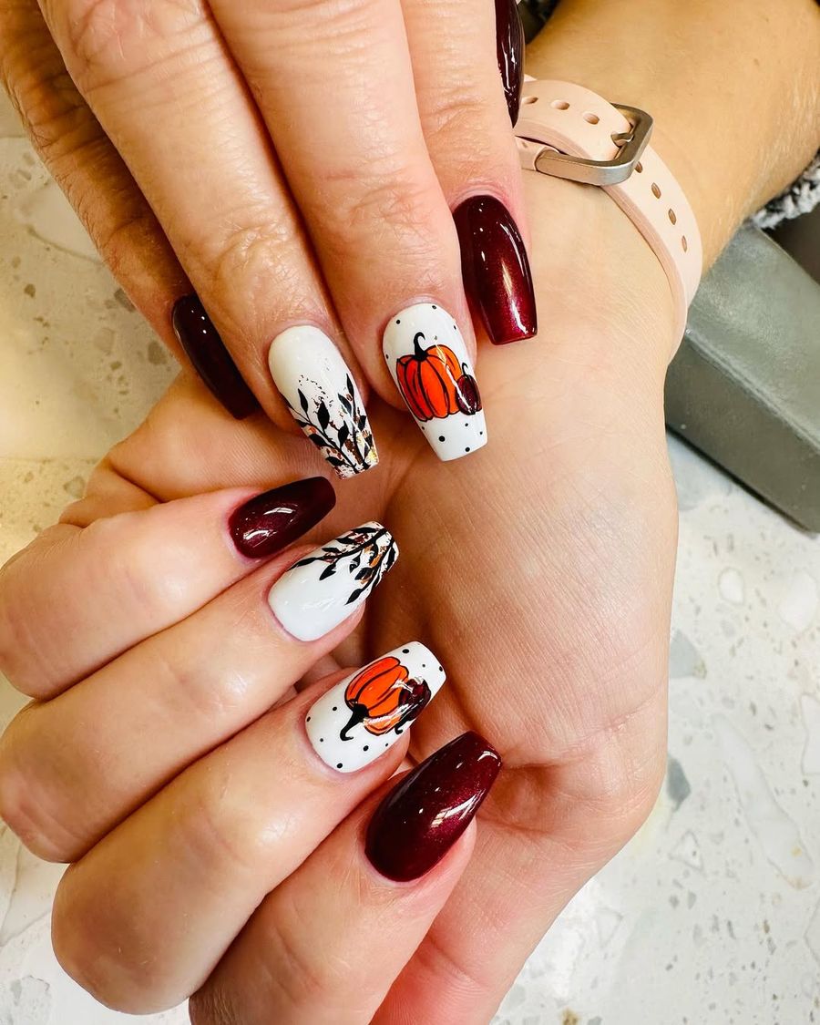Burgundy shimmer coffin nails with hand-painted pumpkins